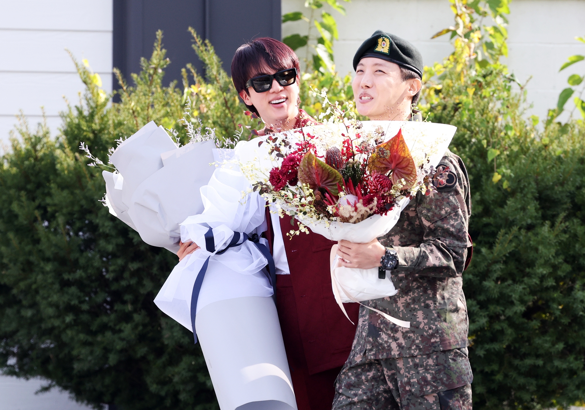 J-Hope, a member of the K-pop sensation BTS, on Oct. 17 is greeted by fellow member Jin after reporting his discharge from the Republic of Korea Army's 36th Infantry Division in Wonju,Gangwon-do Province. (Yonhap News)