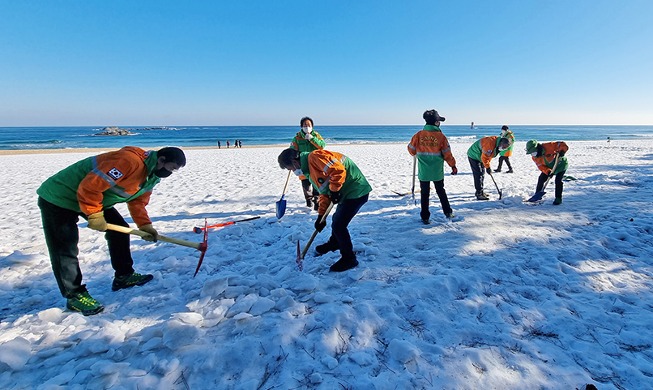 Removing ice at Gyeongpo Beach in Gangneung