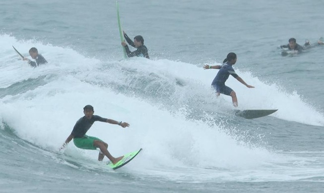 Surfing at Jeju Island's Jungmun Saekdal Beach