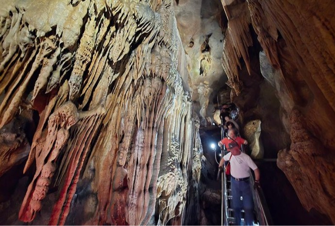 Summer vacationers at natural limestone cave